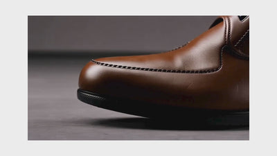 Macro close-up video showing different footwear materials including leather, suede, knit, and athletic fabric highlighting texture and craftsmanship.